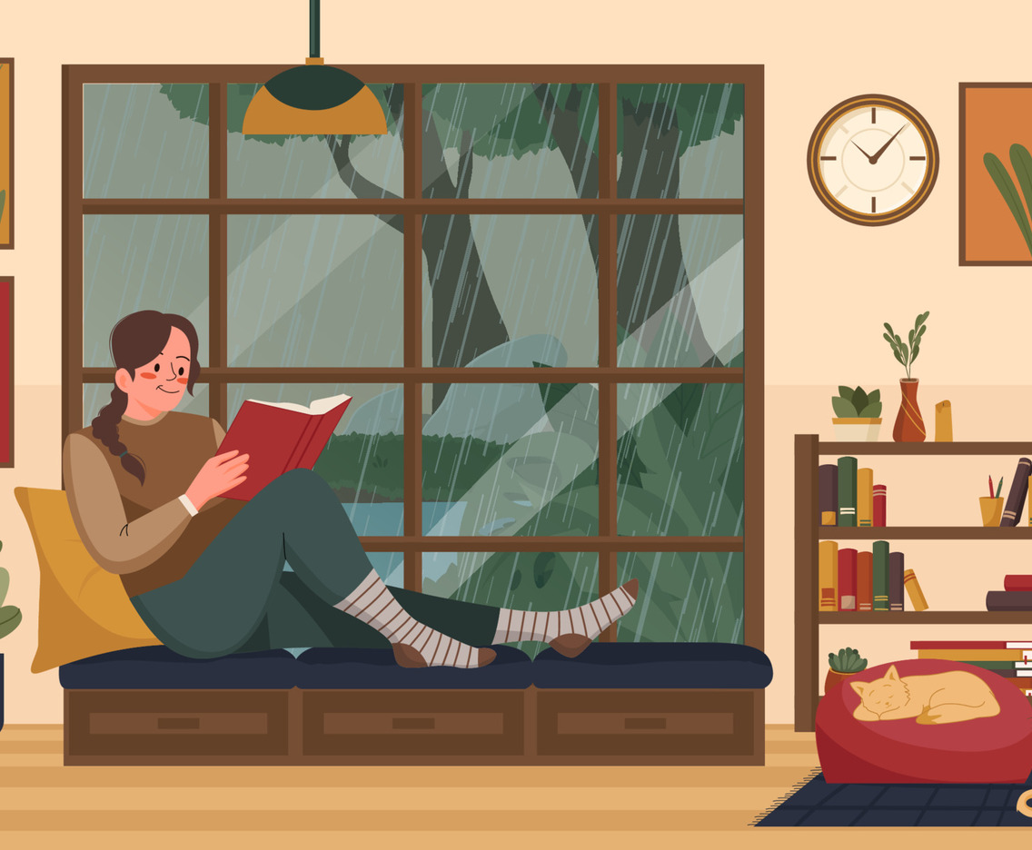 Woman reading a book on a rainy day