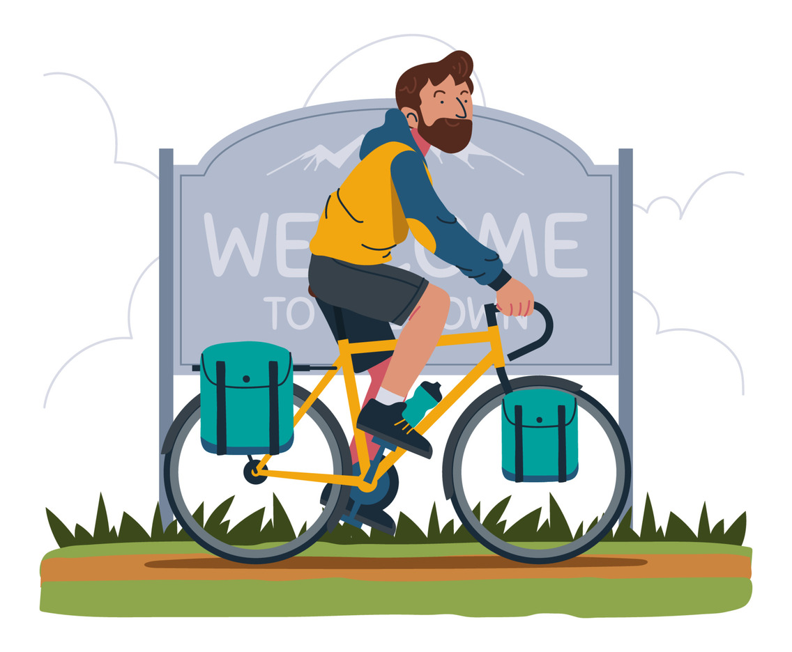 Touring Cyclist Passing Welcome Sign